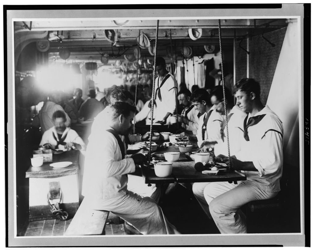 Sailors taking a meal on USS Olympia